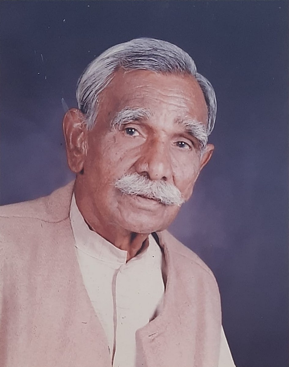 Portrait photograph of Thakur Ram Singh, founder of Shaheed Smarak, Sanjay Place, Agra — an elderly man with white hair and a white moustache, wearing a kurta and a light waistcoat